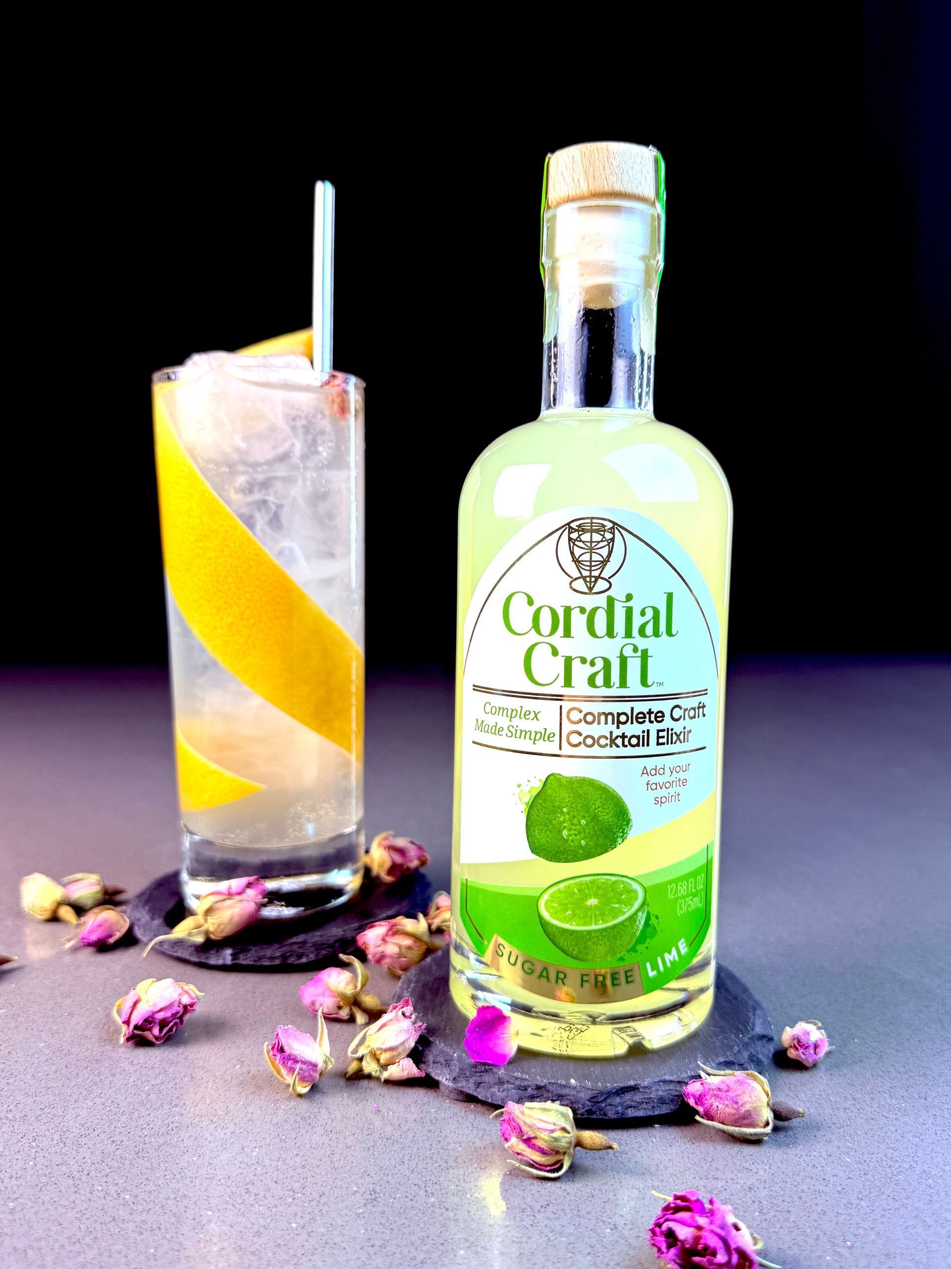 Three bottles of cordial craft are sitting on a wooden table.