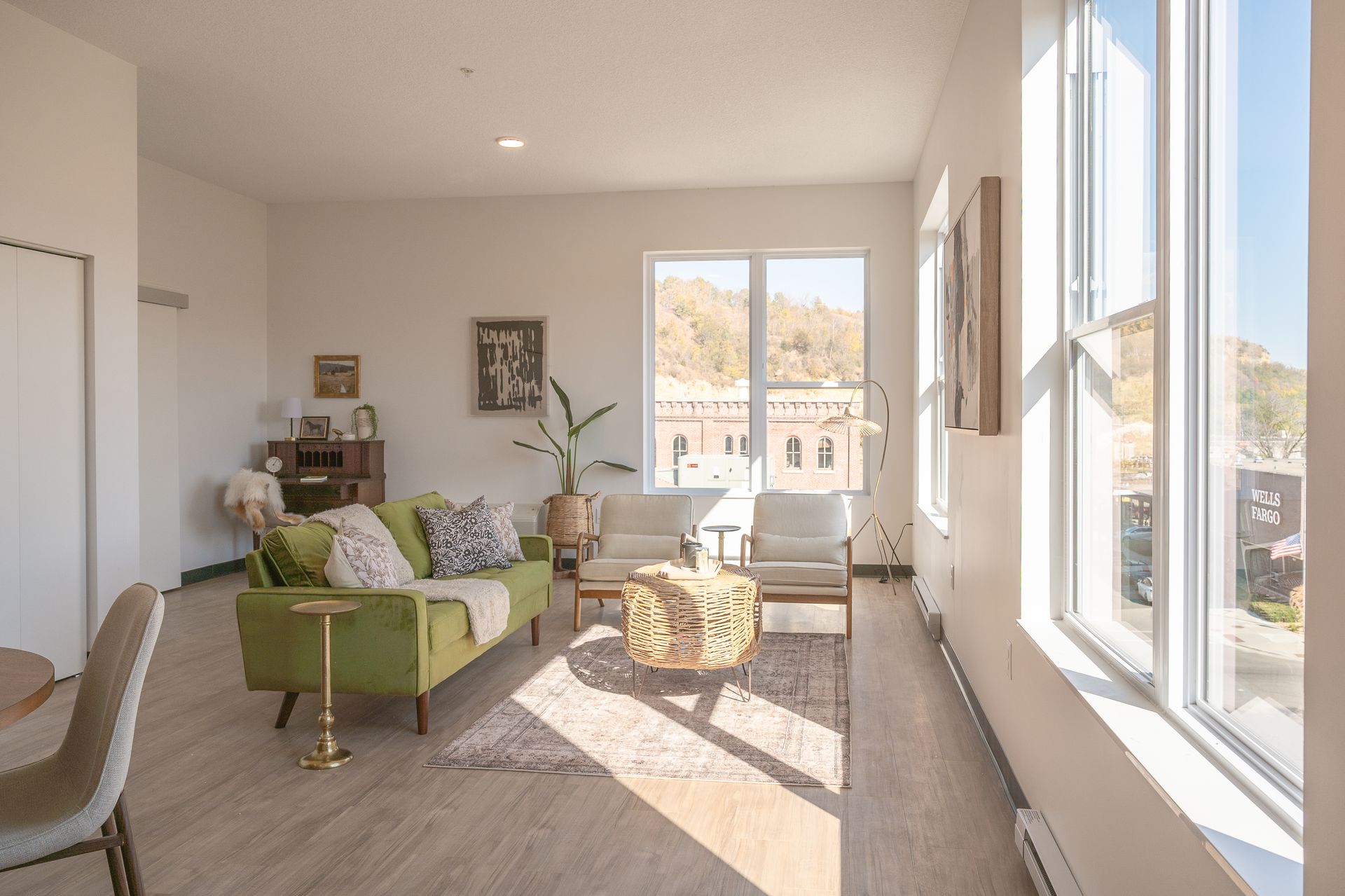 An artist 's impression of a living room and kitchen in a house.