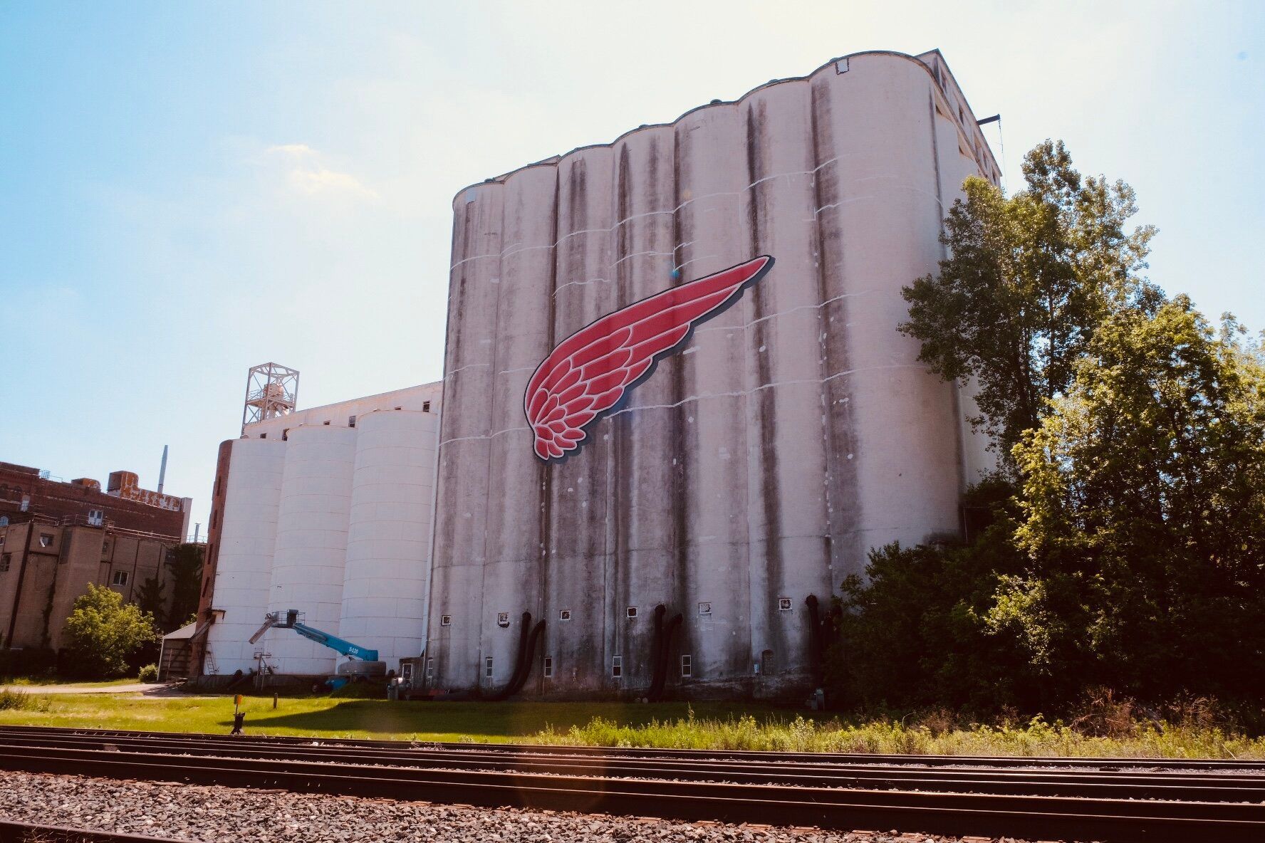 A large white building with a red wing painted on it