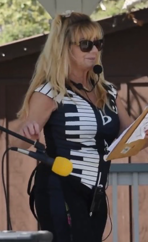 A woman wearing a black and white shirt with piano keys on it