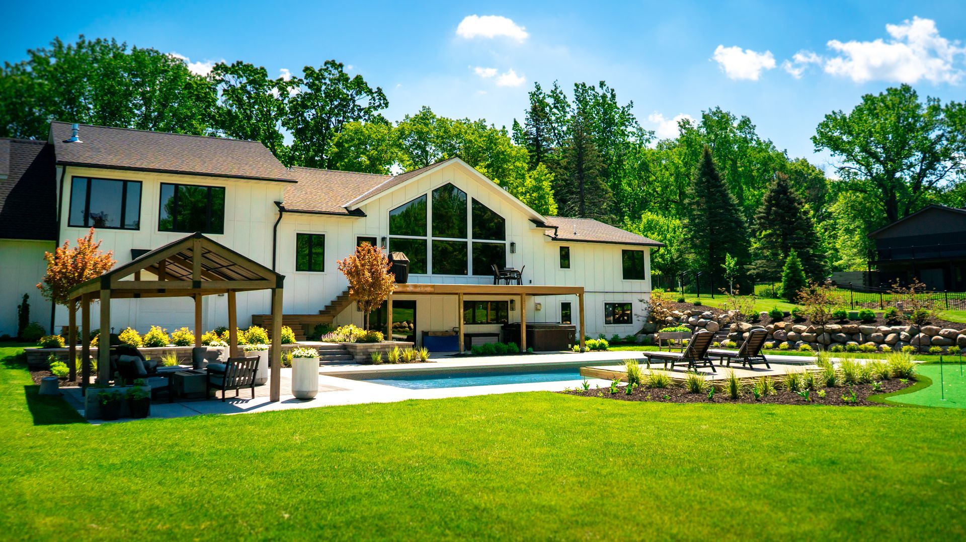 A large white house with a large lawn in front of it.