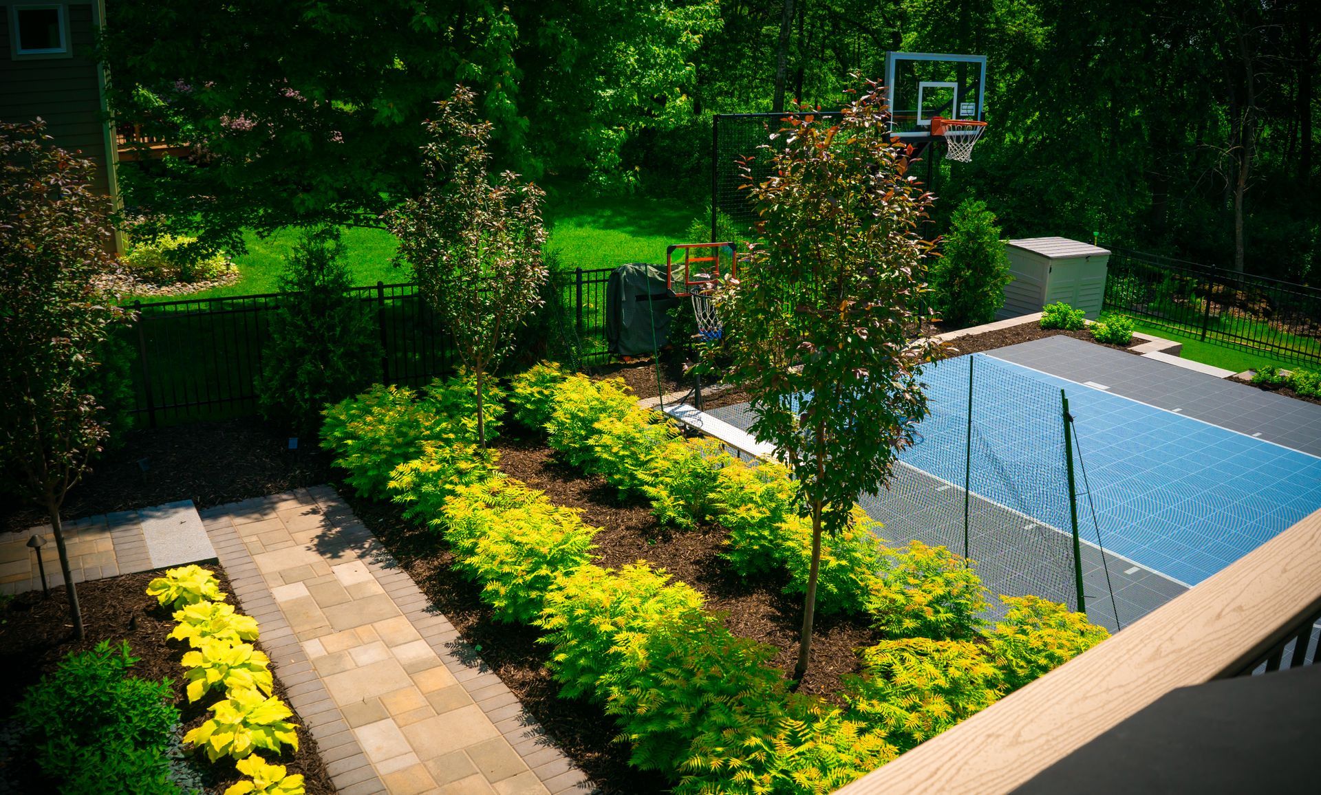 An aerial view of a basketball court in a backyard