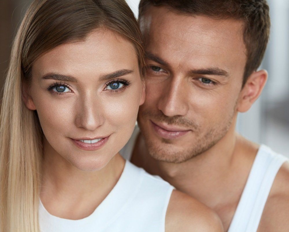 A man and a woman are posing for a picture together