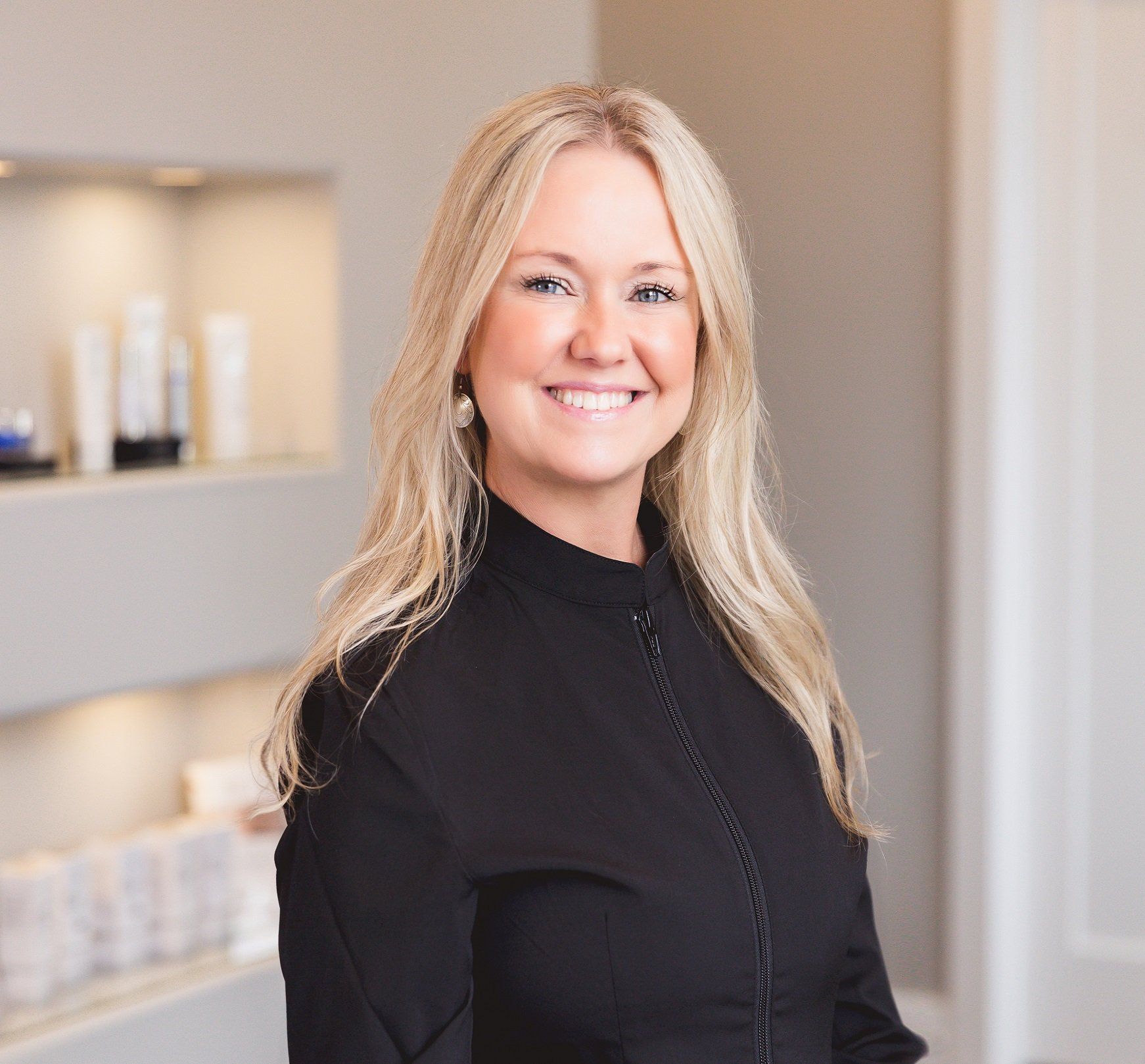 A woman in a black shirt is smiling for the camera