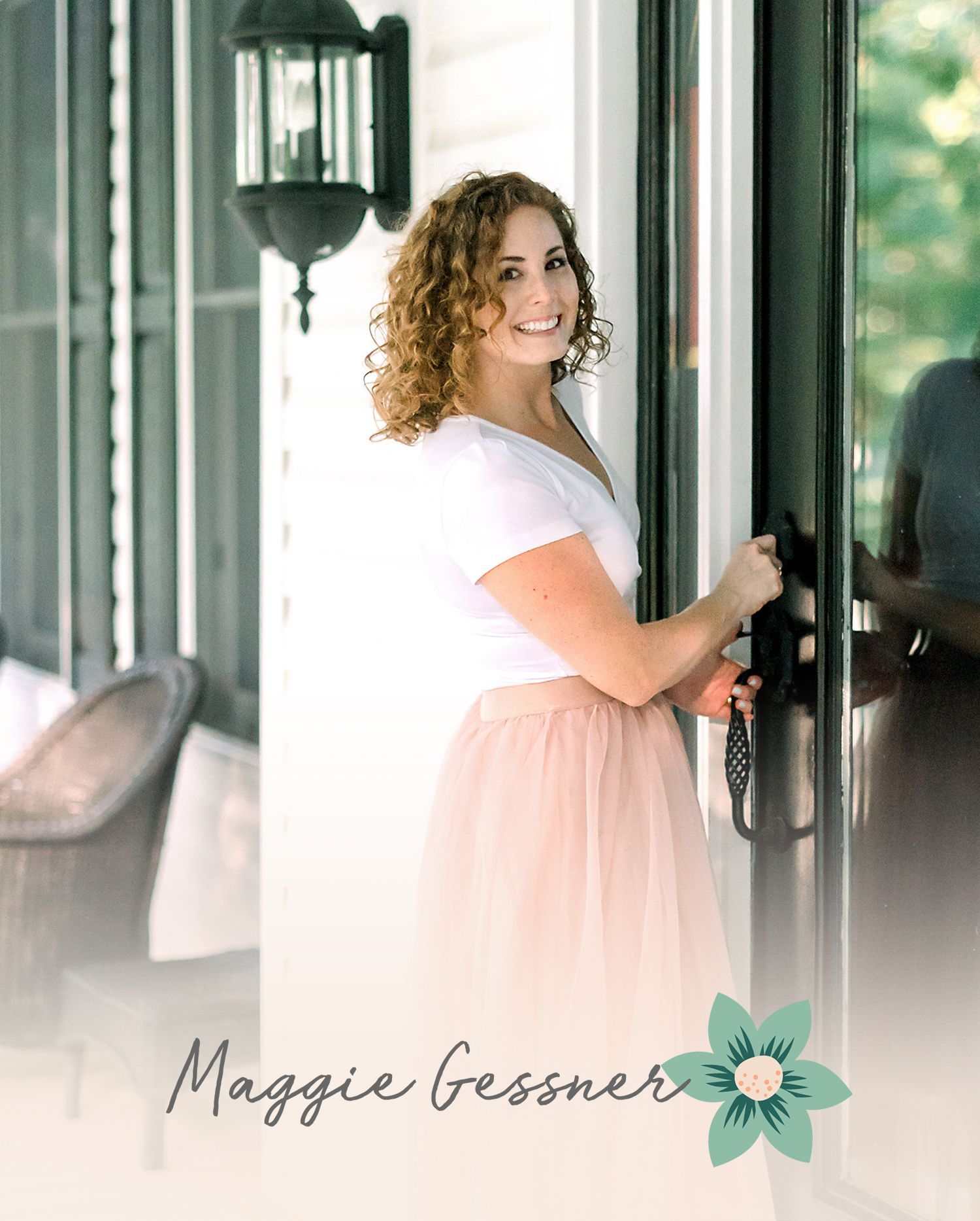 A woman in a white shirt and pink skirt is standing in front of a door.