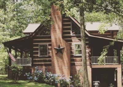 A log cabin with a star on the chimney
