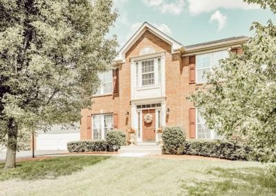 A large brick house with a wreath on the front door