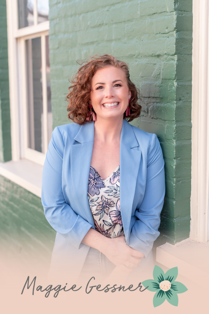A woman in a blue jacket is leaning against a green brick wall.