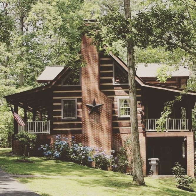 A log cabin with a star on the chimney