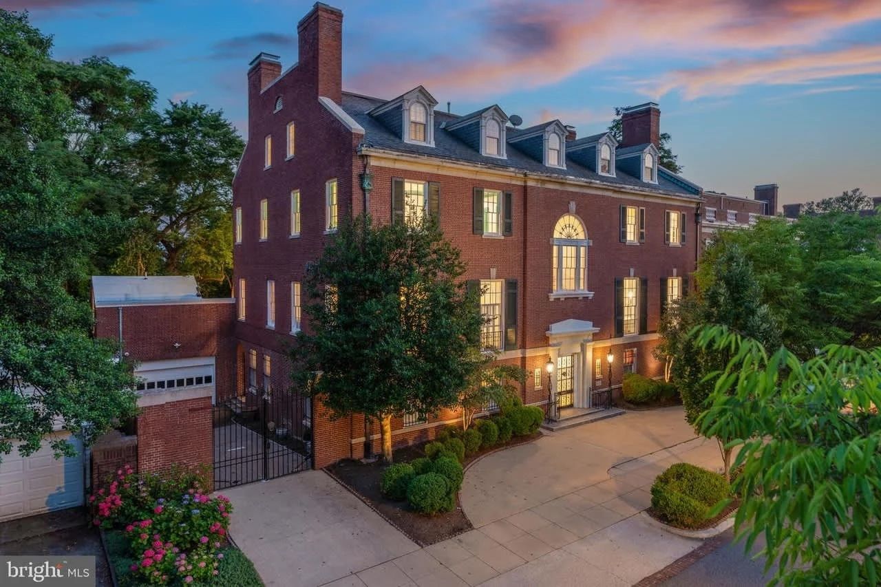 An aerial view of a large brick building with a driveway in front of it.