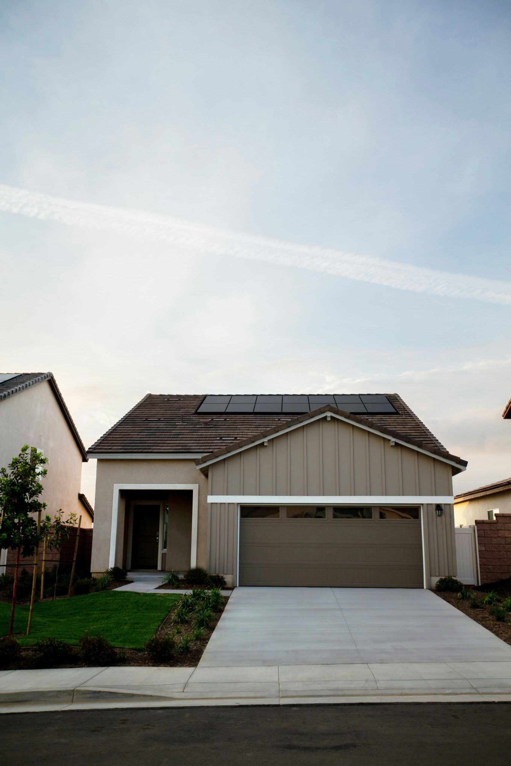 A house with a garage and solar panels on the roof.