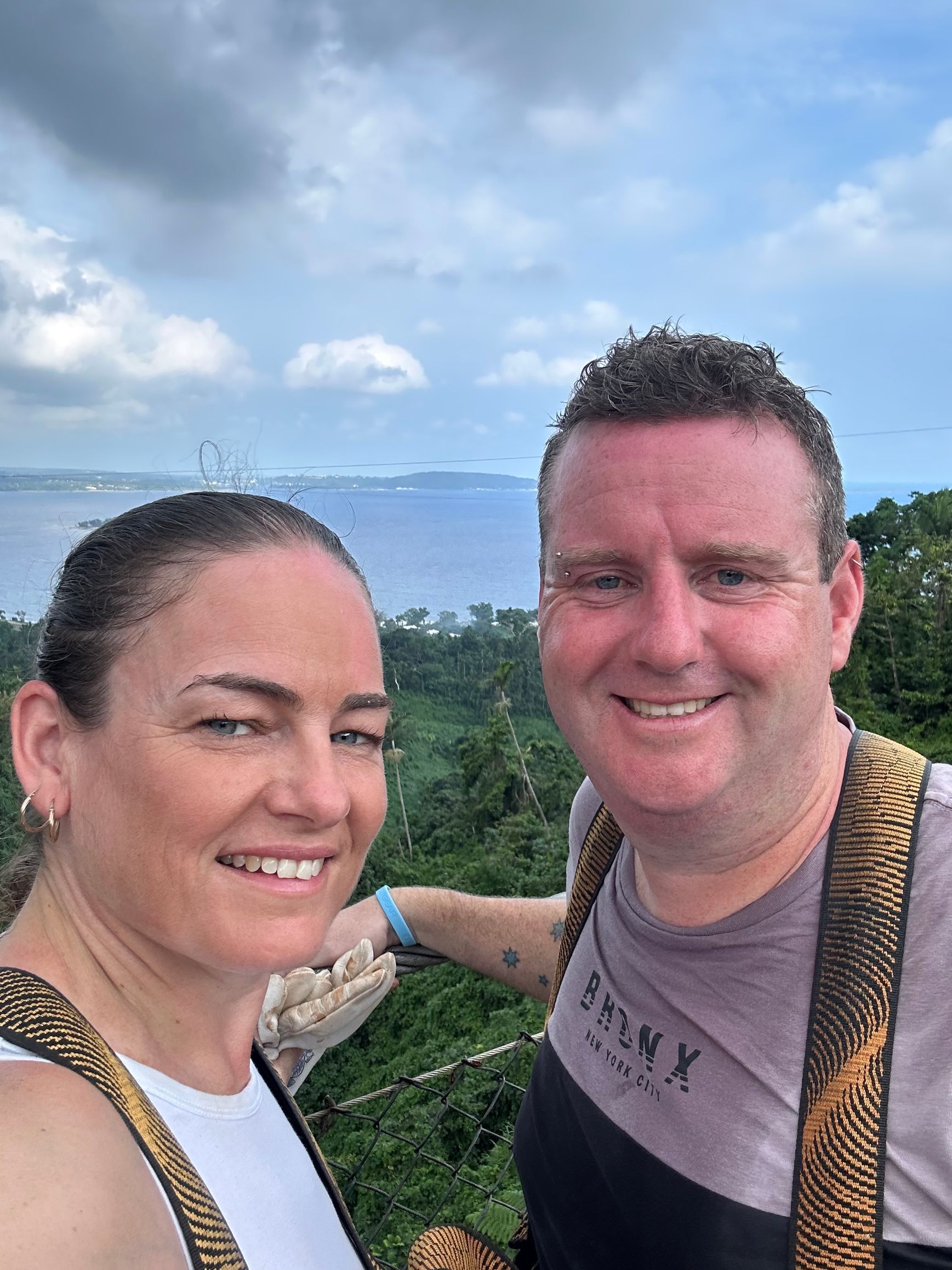 A man and a woman are standing next to each other and smiling for a picture.