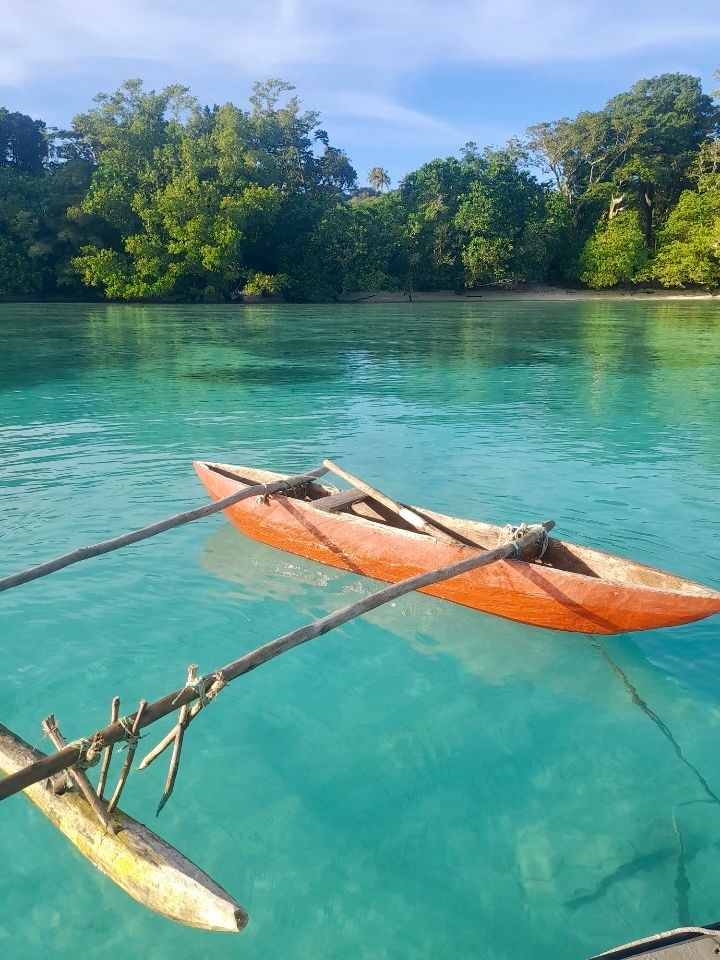 A boat is floating on top of a body of water.