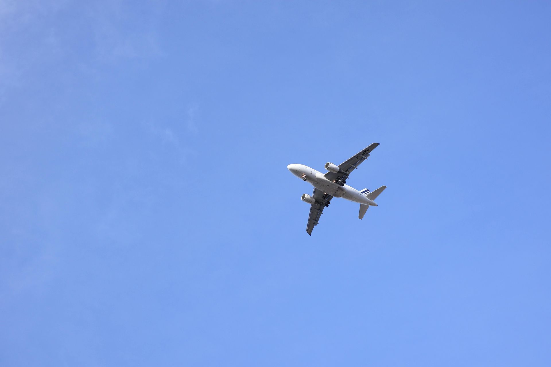 Airplane in flight against a clear blue sky.