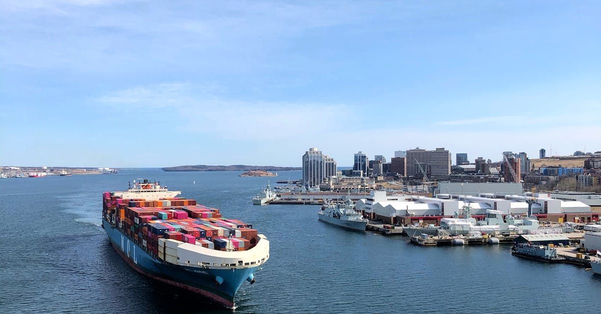 A large container ship is docked in a harbor.