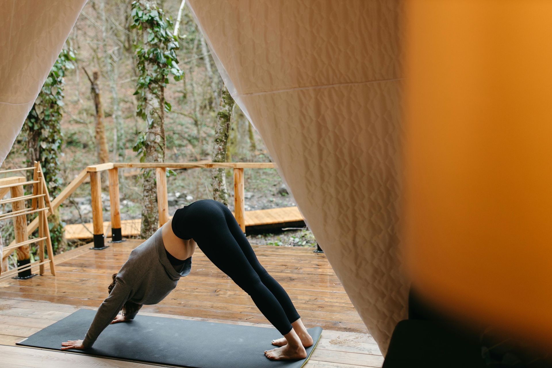 A woman is doing a yoga pose on a mat.