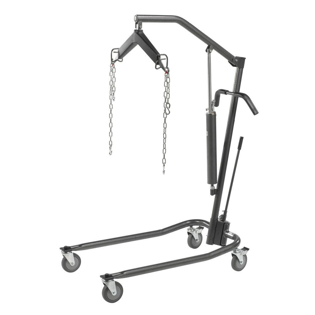A dark gray hydraulic patient lift for medical use, featuring a spreader bar, lifting arm, and four rolling casters.