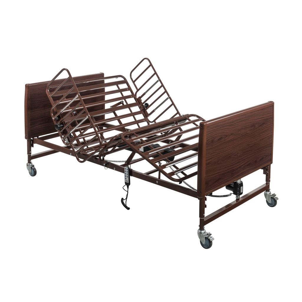 An adjustable hospital bed with a metal wire frame and brown wooden headboard and footboard on rolling casters.