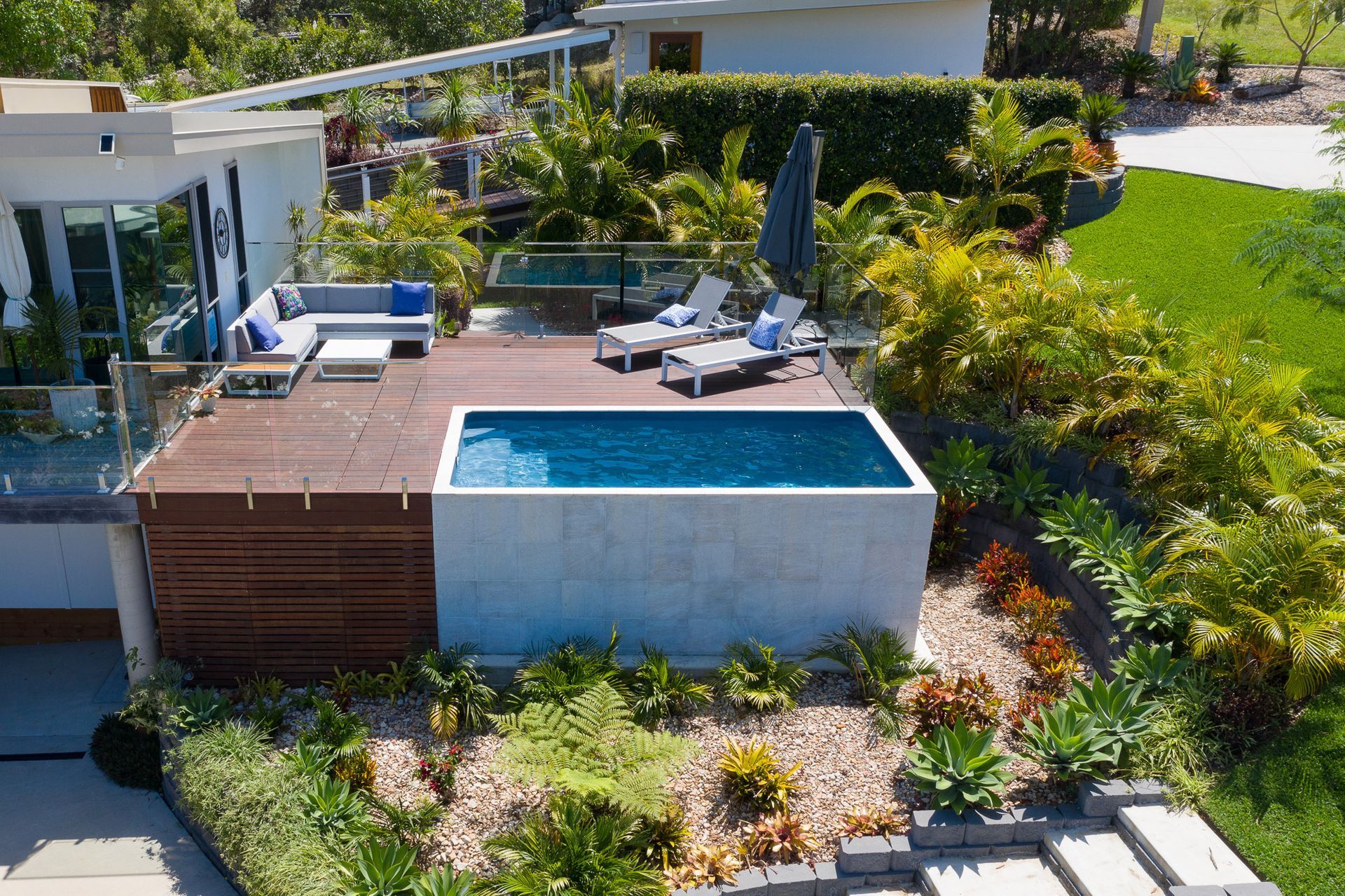 An aerial view of a Plungie swimming pool above ground in the backyard of a house.