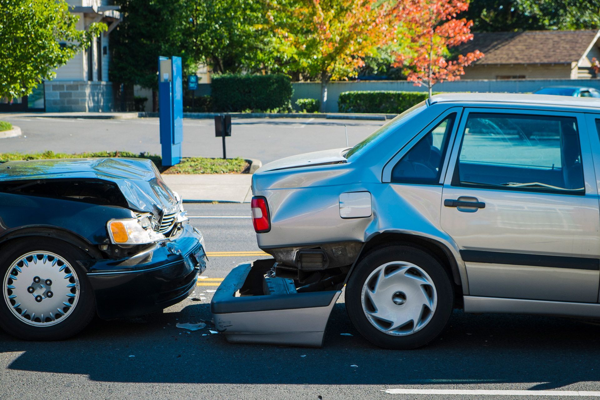 Two cars are involved in a car accident on the street.