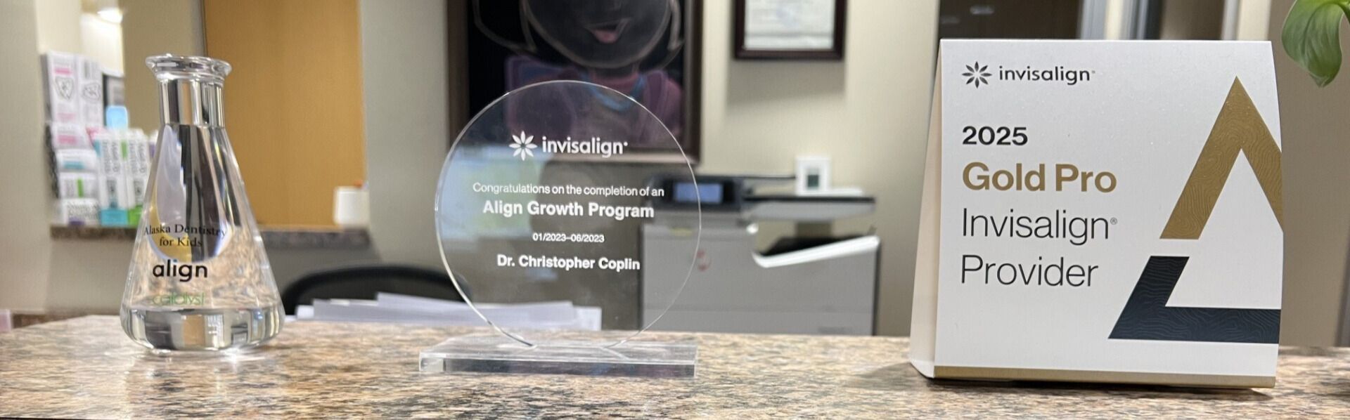 Clear acrylic award with the Invisalign logo and text: