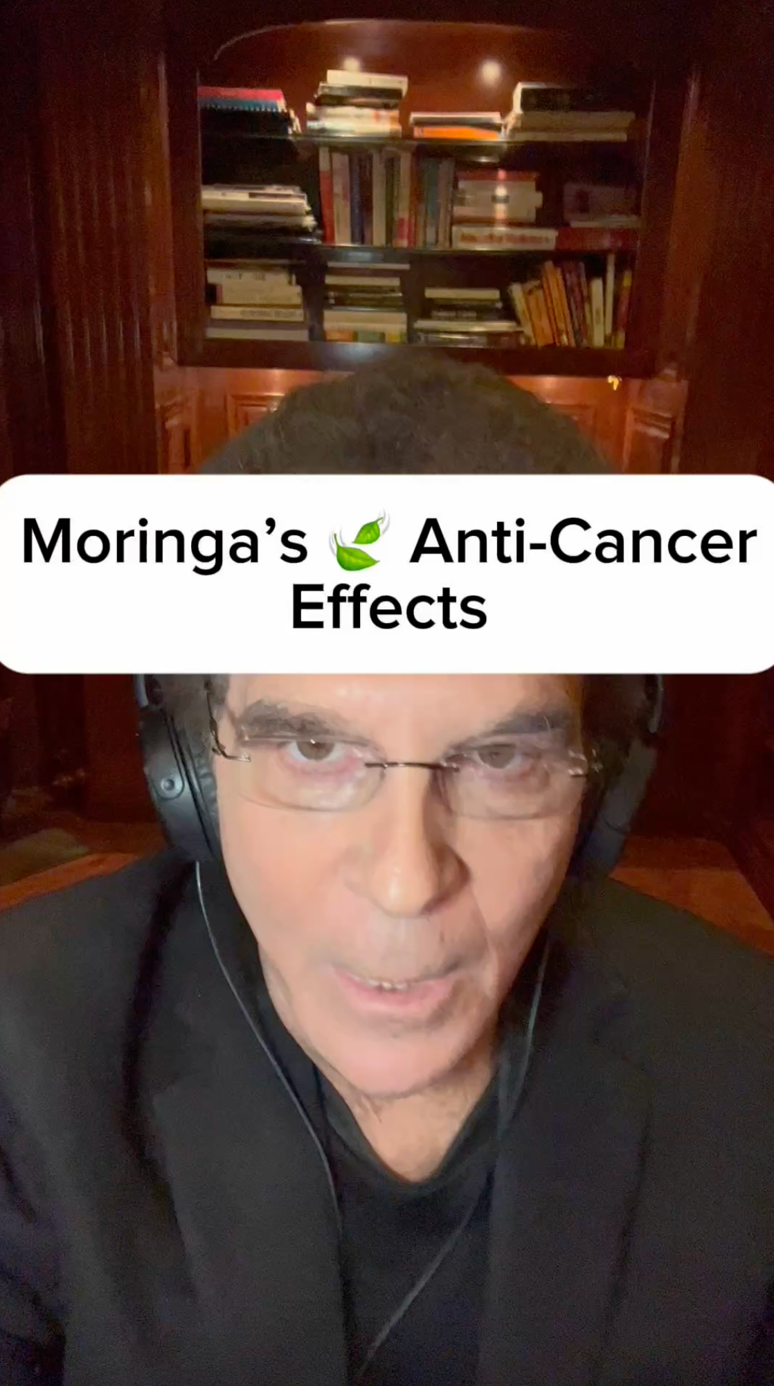 Man wearing headphones, text: Moringa's Anti-Cancer Effects. Bookshelf background.