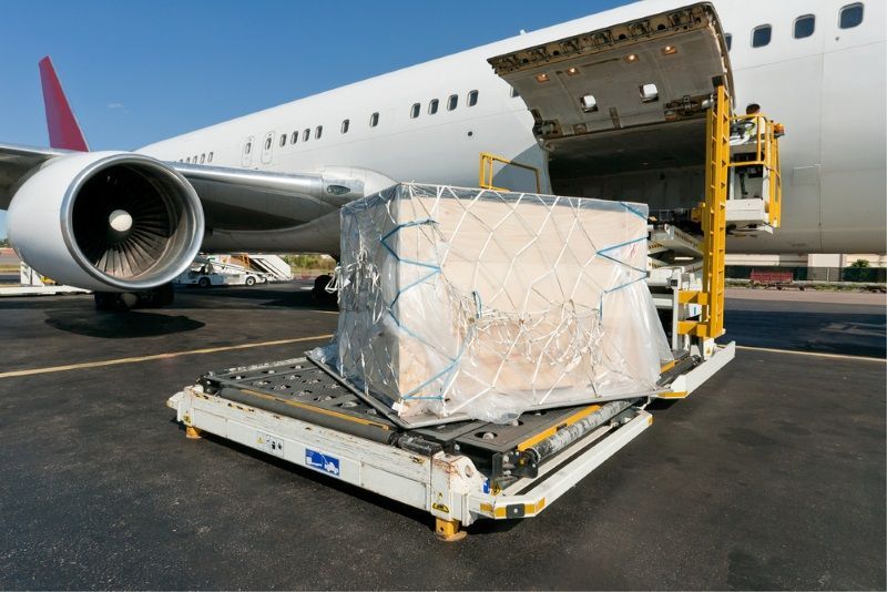 An airplane is being loaded with cargo on the tarmac.
