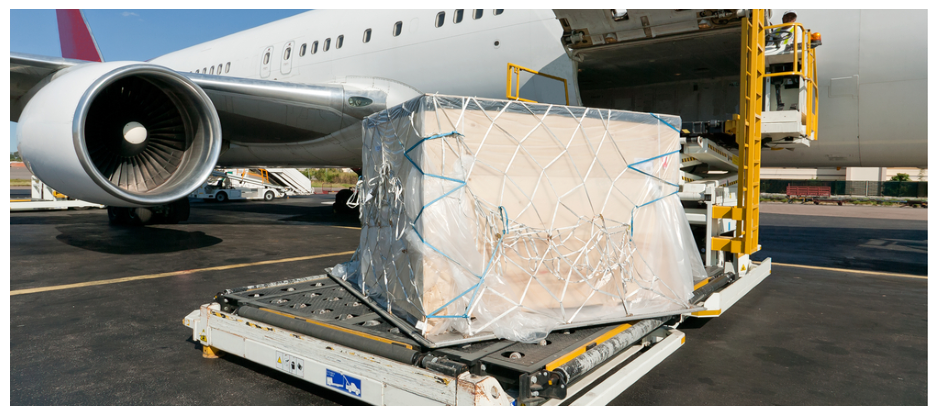 A large cargo box is being loaded into an airplane.