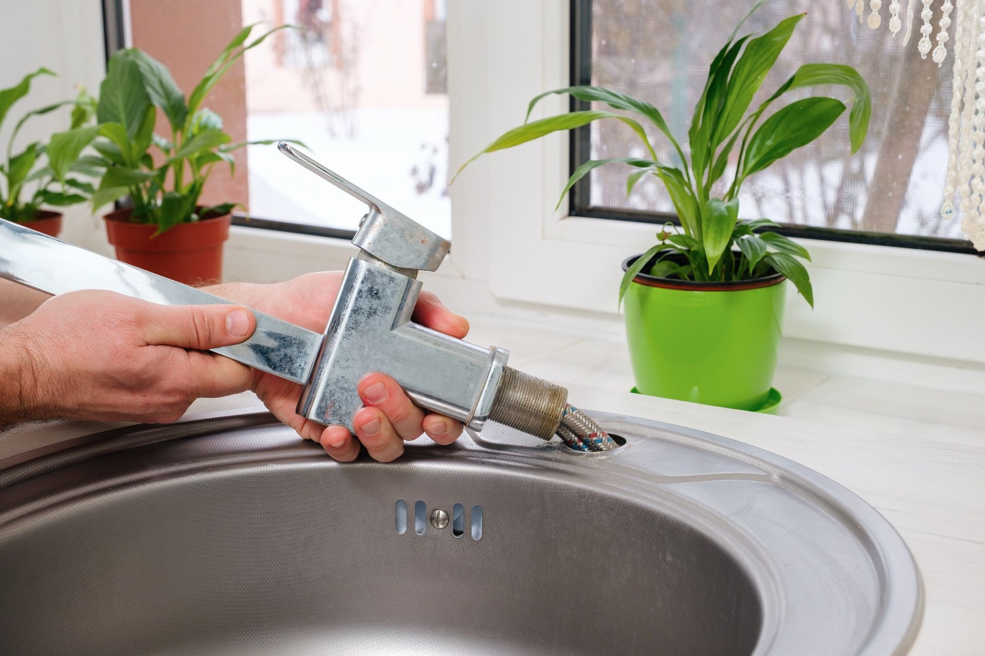 Repairing a faucet over a sink.