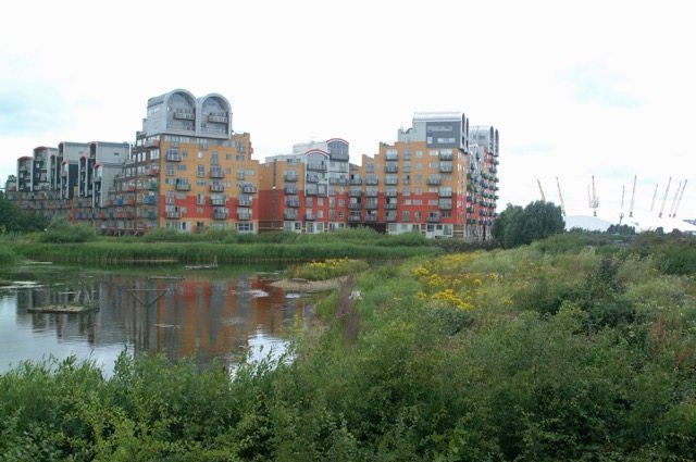 A group of buildings sitting next to a body of water.