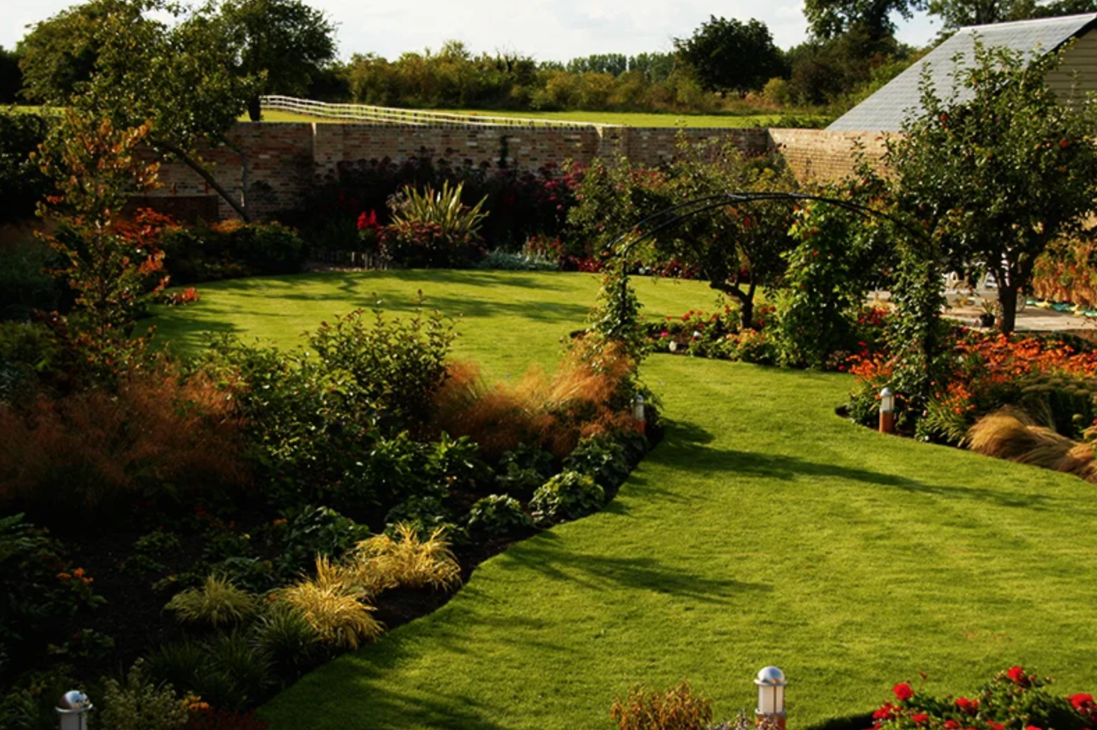 A large lush green lawn with a house in the background