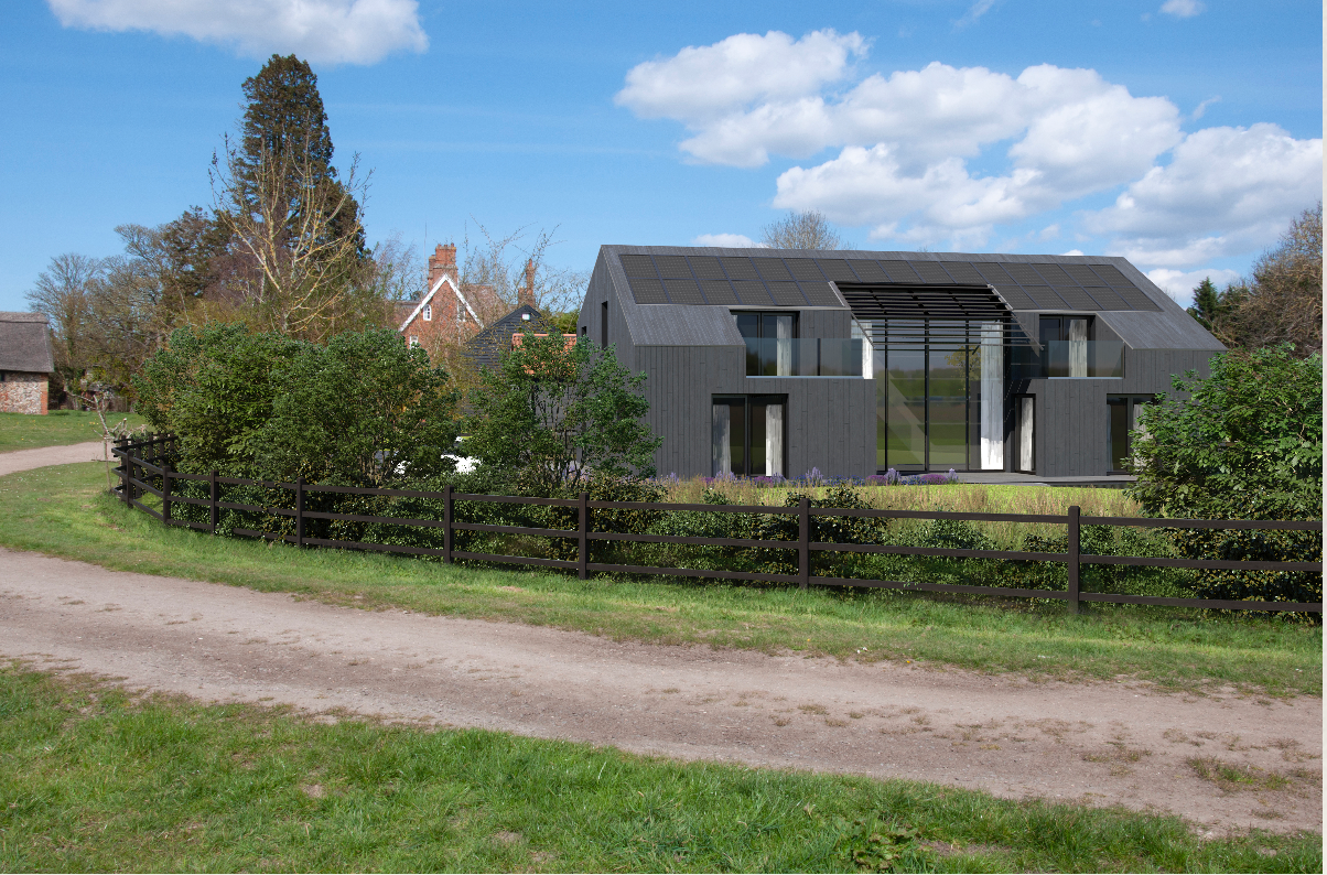 A large house is sitting in the middle of a grassy field next to a dirt road.