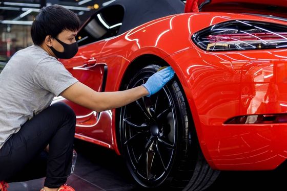 Man touching car on the wheel