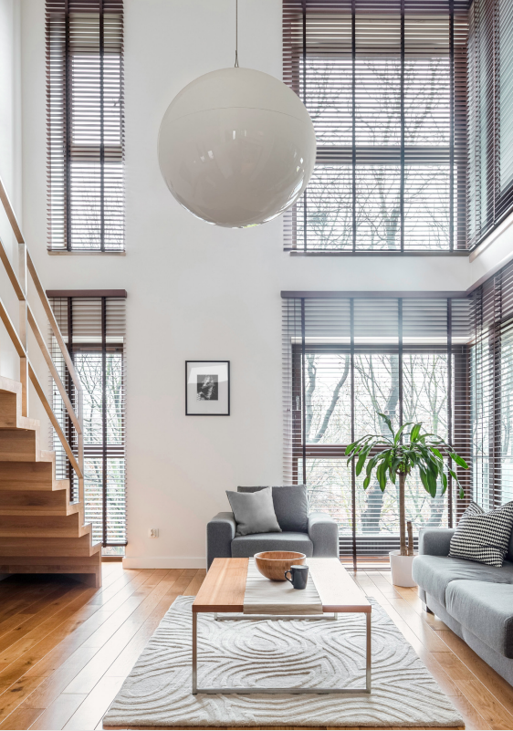 a living room with a couch and a coffee table and a hanging infrared light providing radiant heat vs central heating radiators