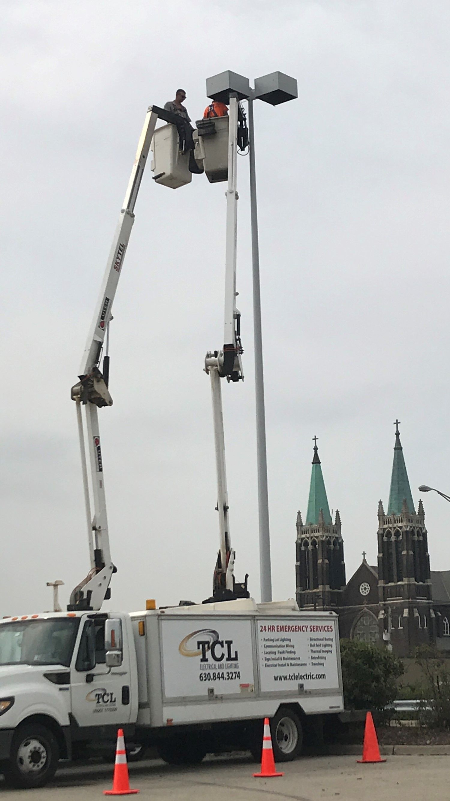 Electrician testing electrical panel with a multimeter.