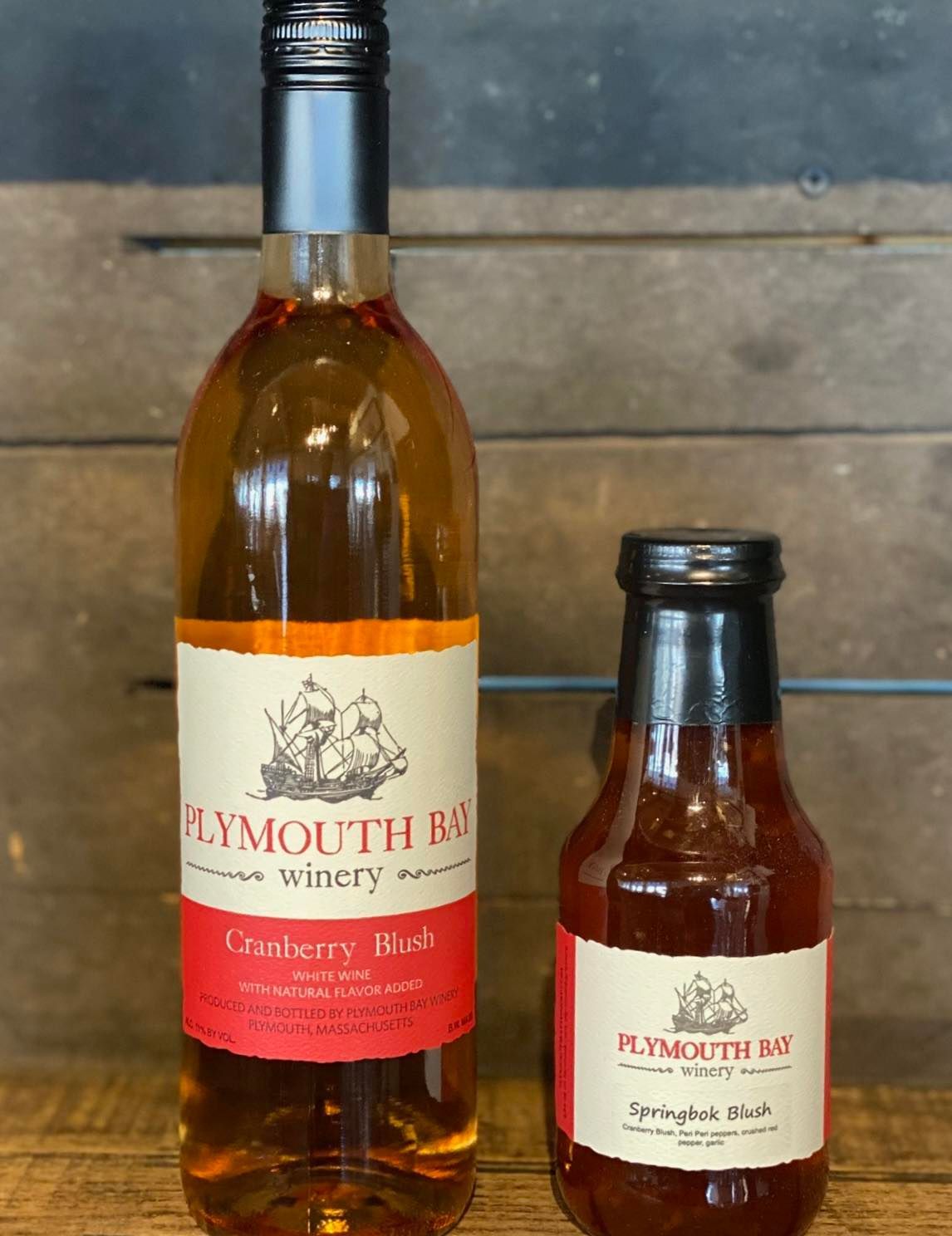 Plymouth Bay Winery bottles: Cranberry Blush and Springfish Shark with red labels.