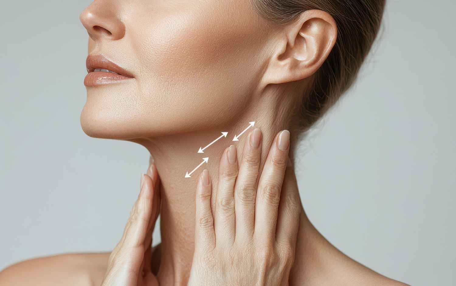Woman's face and neck, hands gently holding skin. White arrows show lifting direction.