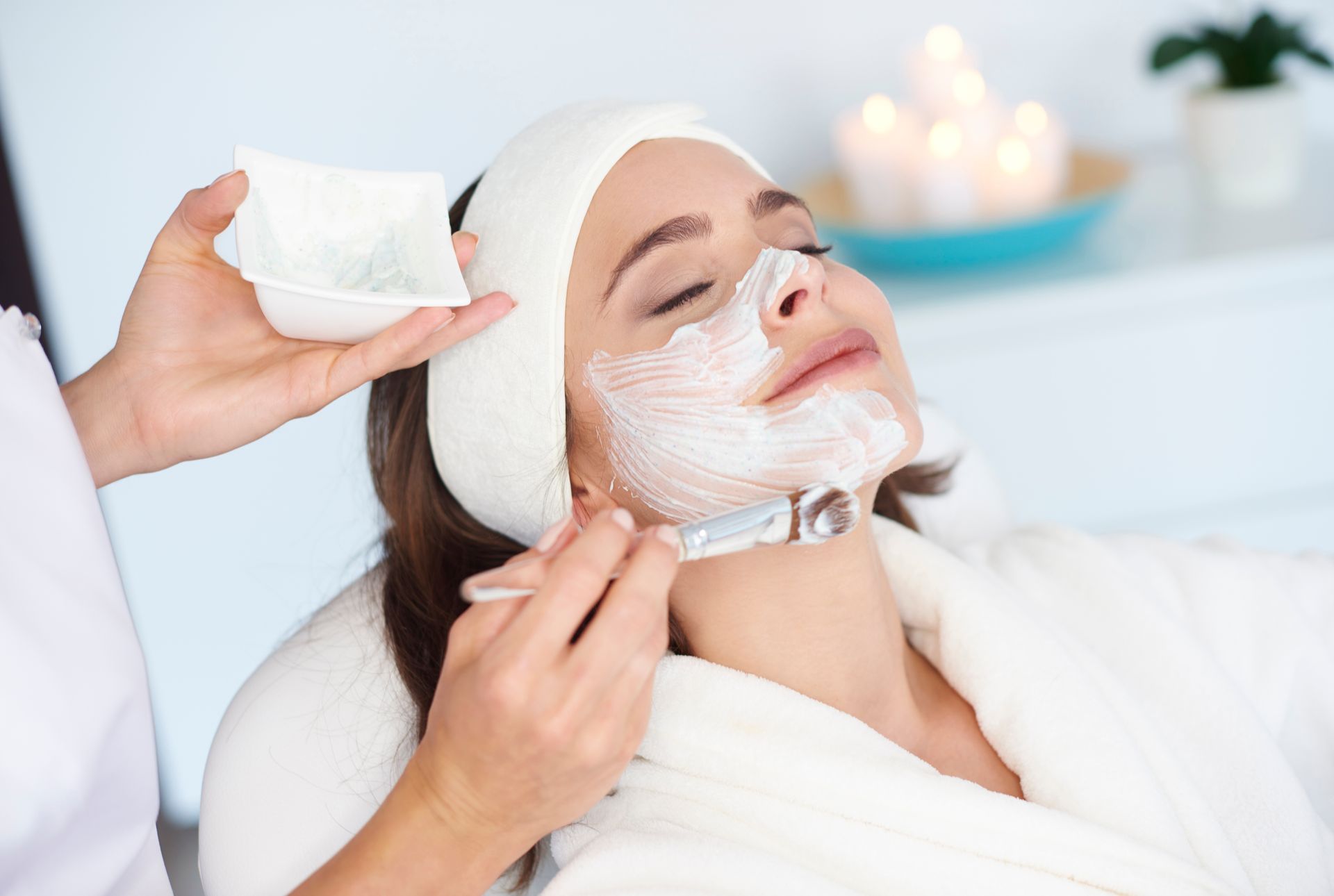 A woman is getting a facial treatment at a spa.