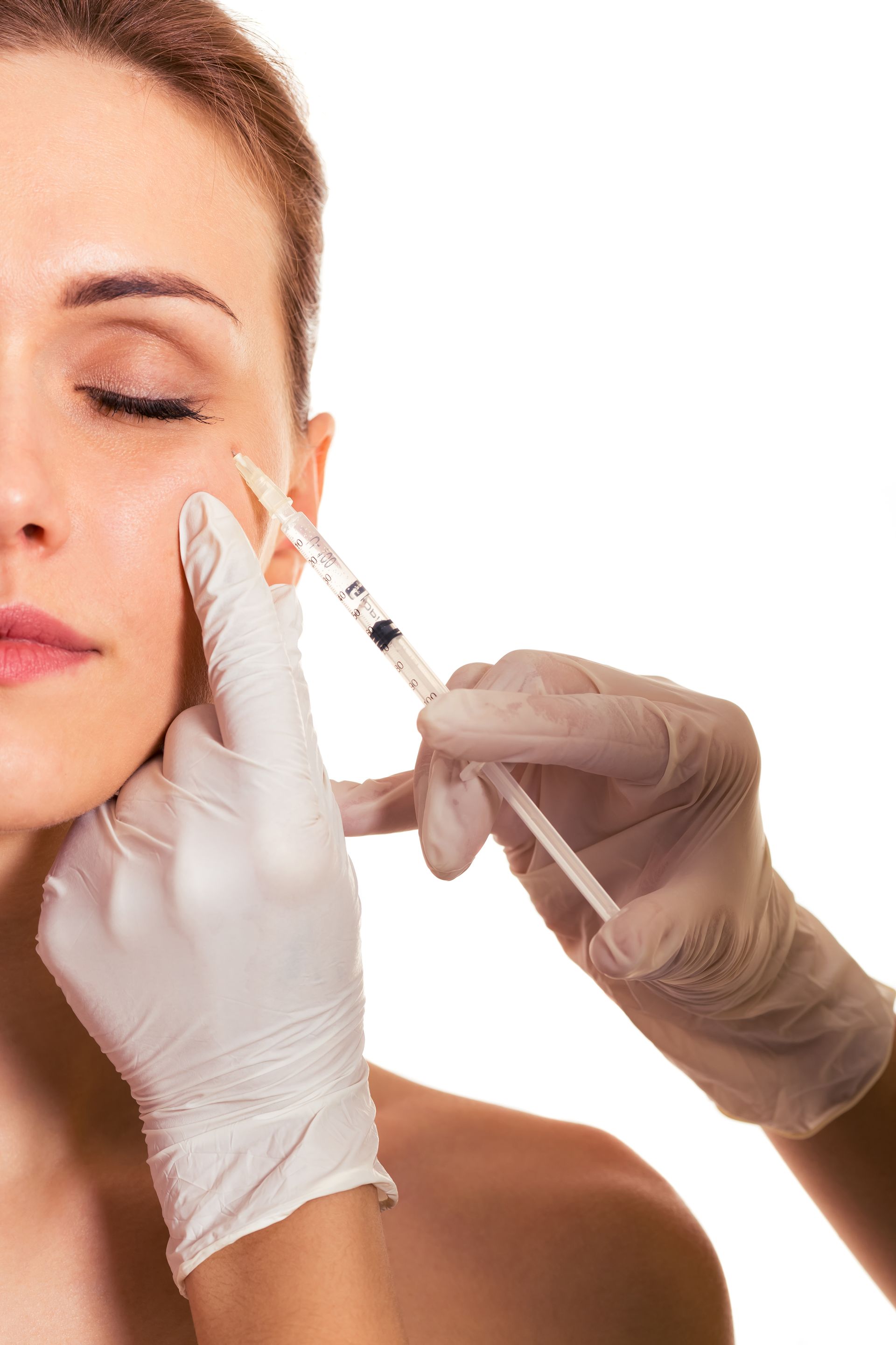 A woman is getting a botox injection in her face.