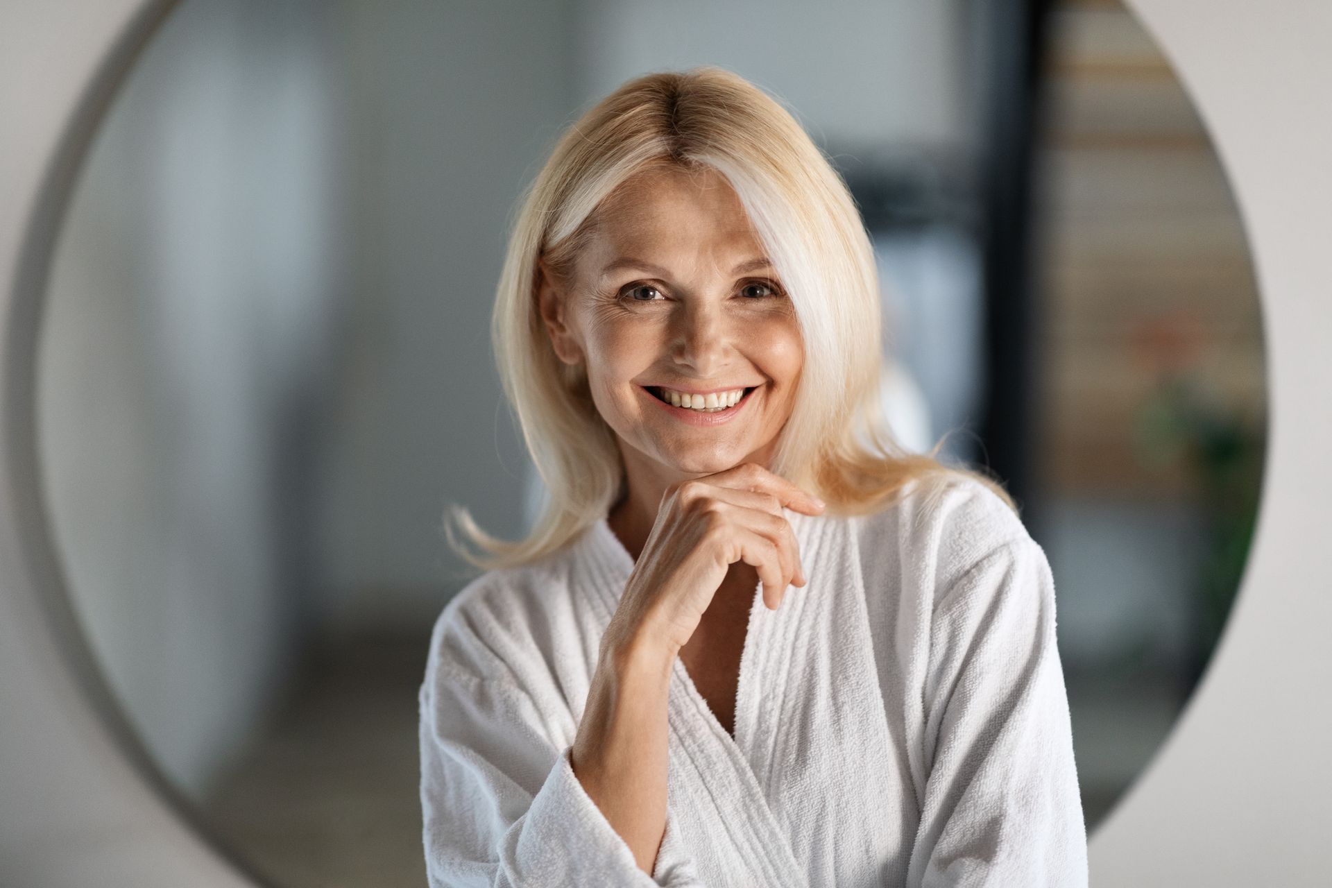 A woman without a shirt is looking over her shoulder at the camera.