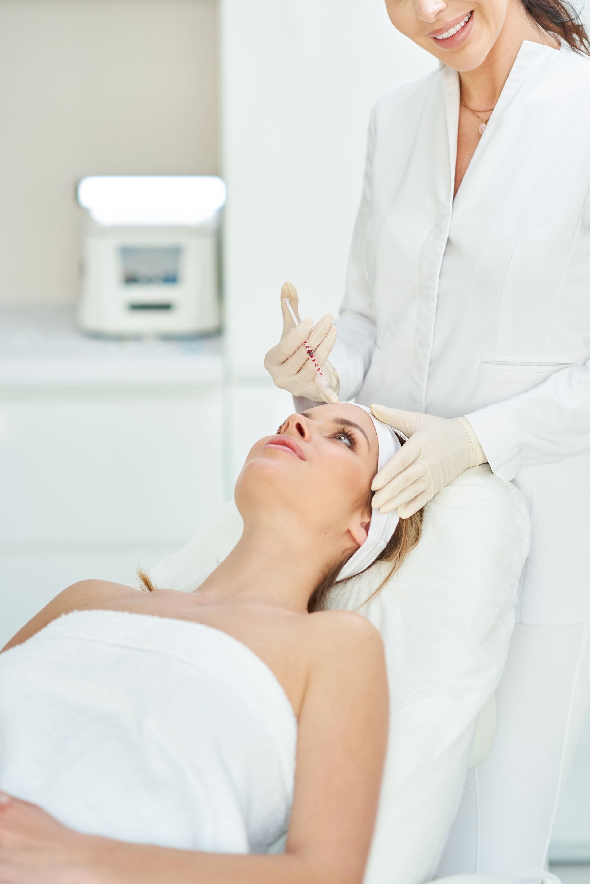 A woman is getting a facial treatment at a spa.