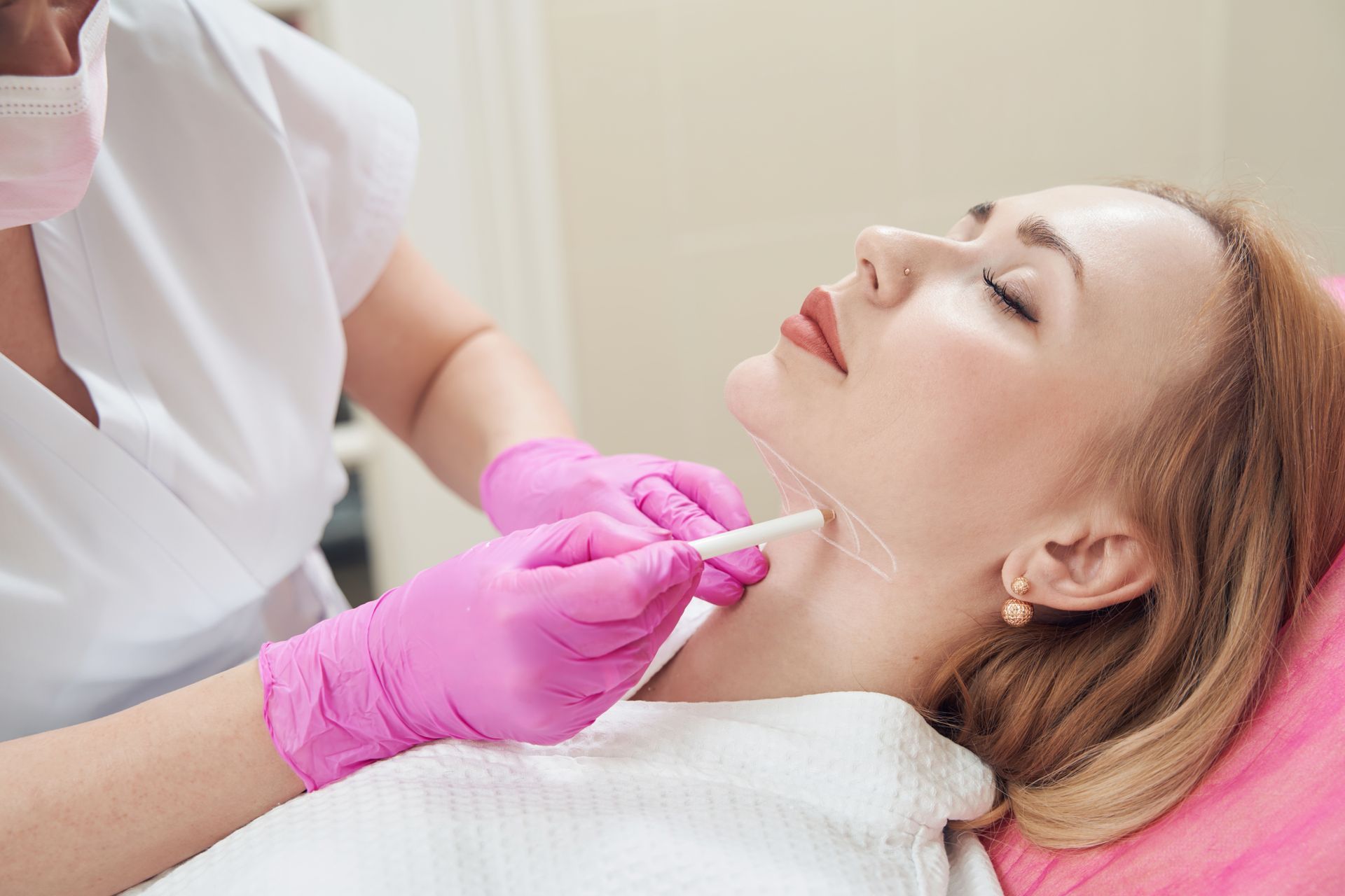 A woman is getting a botox injection in her neck.