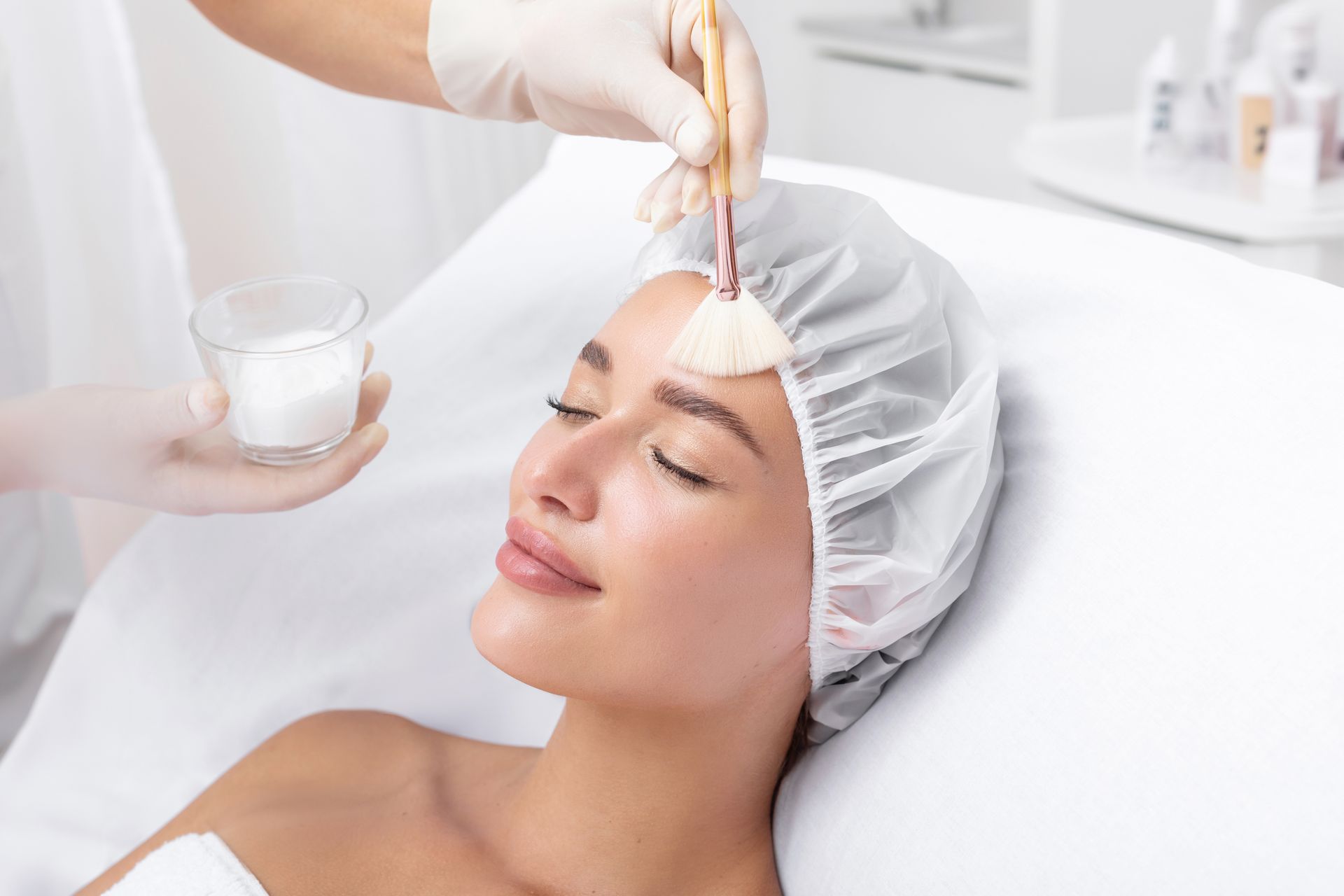 A woman is getting a facial treatment at a beauty salon.