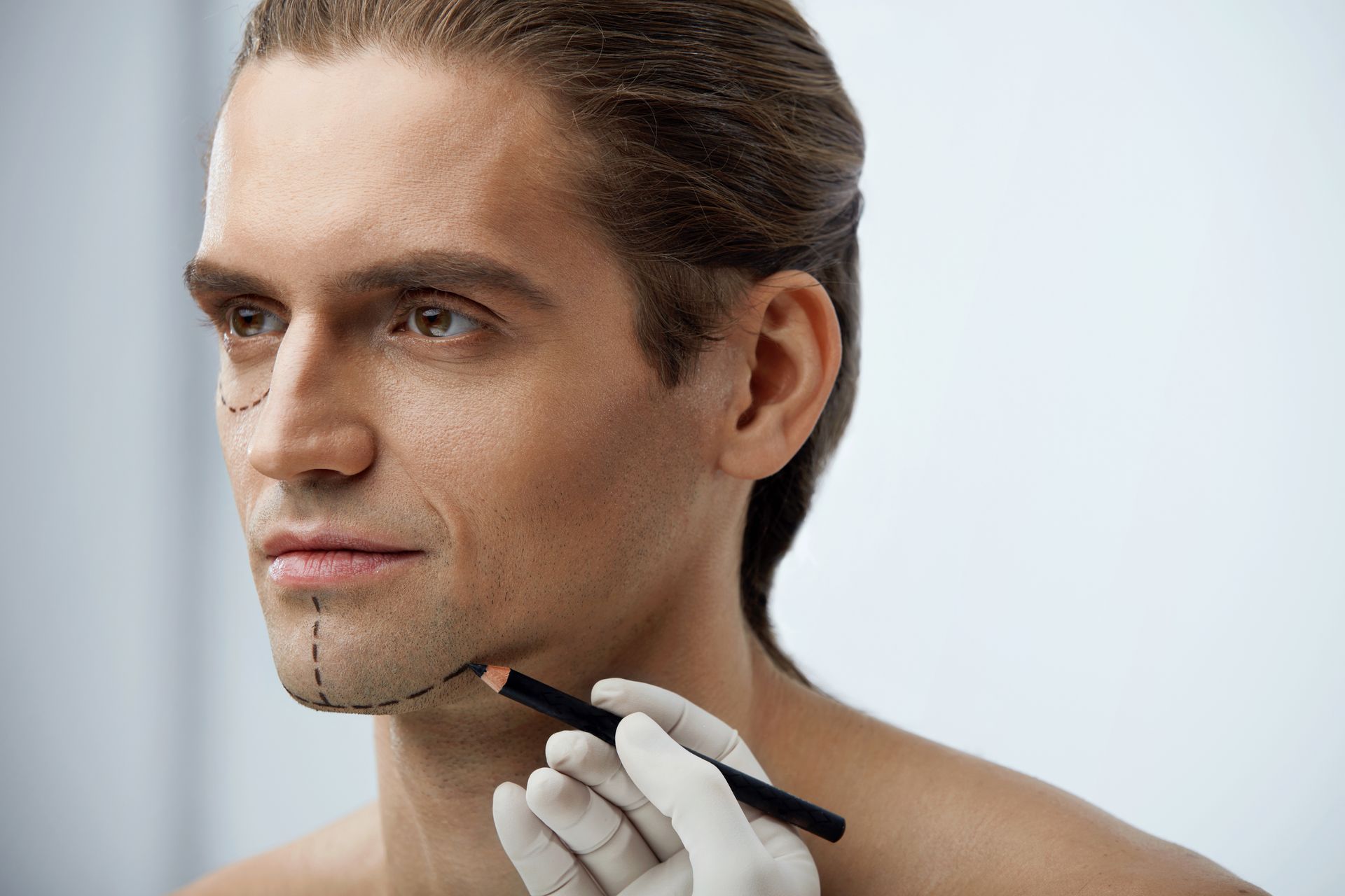 A man is getting a plastic surgery on his face.