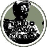A black and white photo of a man in a circle with the words `` the basement '' written on it.