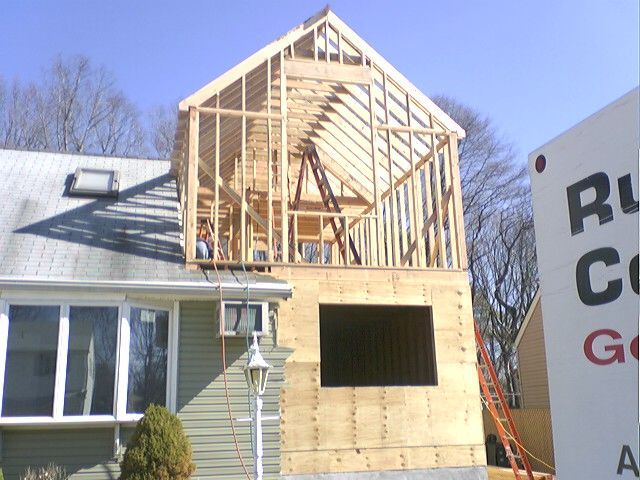 House under construction with exposed wooden frame.