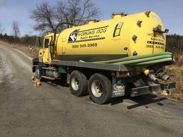 Nice work truck and cute dog outisde in Cambridge VT - Working Dog Septic Services-min