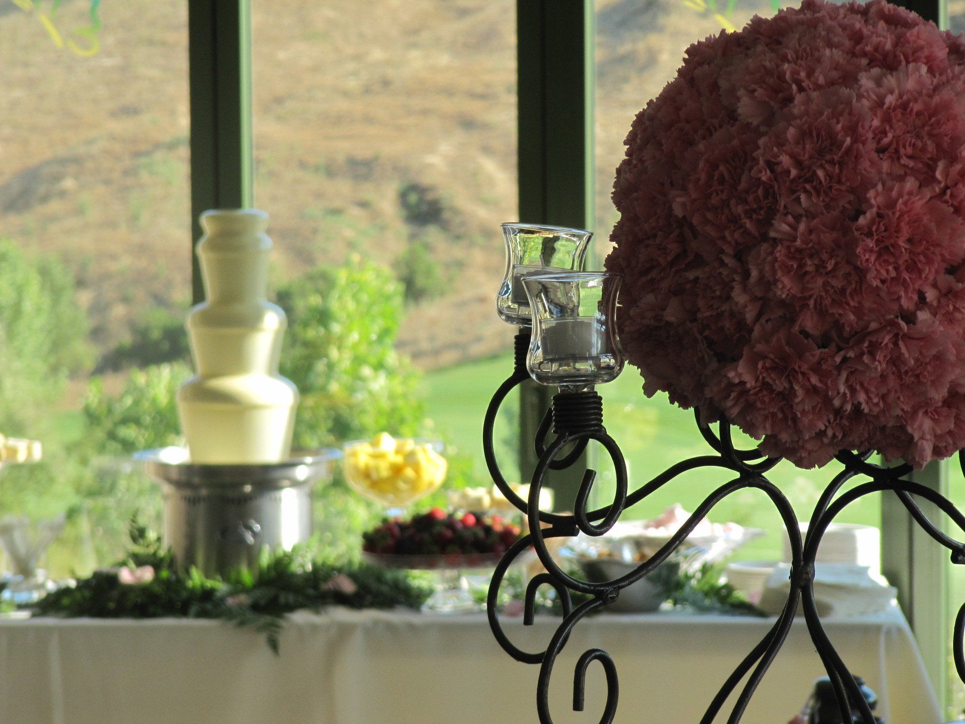 A table with a fountain and flowers on it