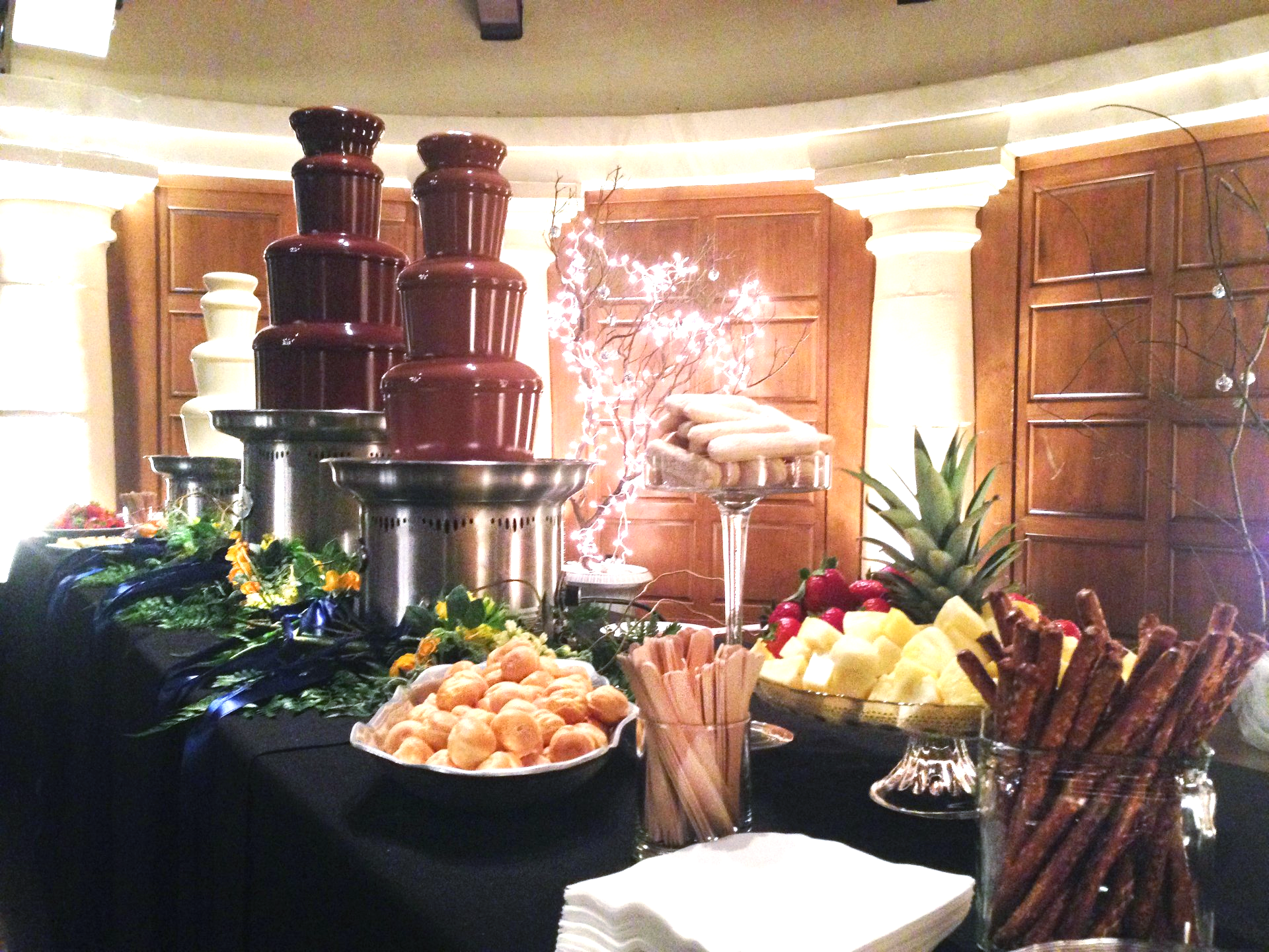A table with a bunch of food and chocolate fountains