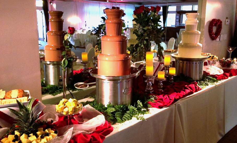 A table with a bunch of chocolate fountains on it